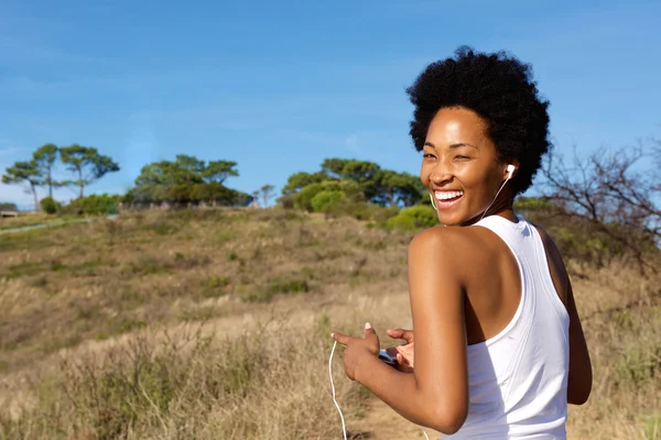 Active woman runner standing in the field