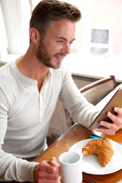 Happy older man looking at tablet