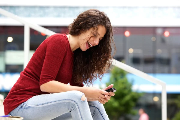 Woman sitting outside with mobile phone
