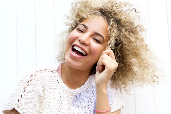 Smiling young woman pulling hair