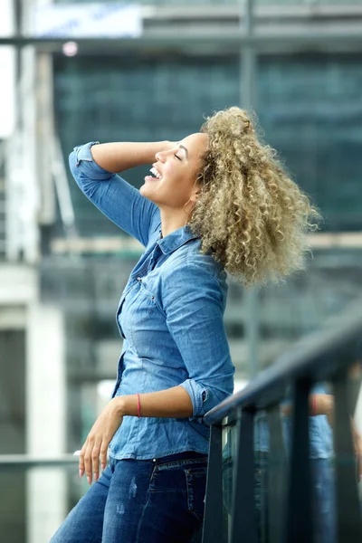 Woman smiling with hand in hair