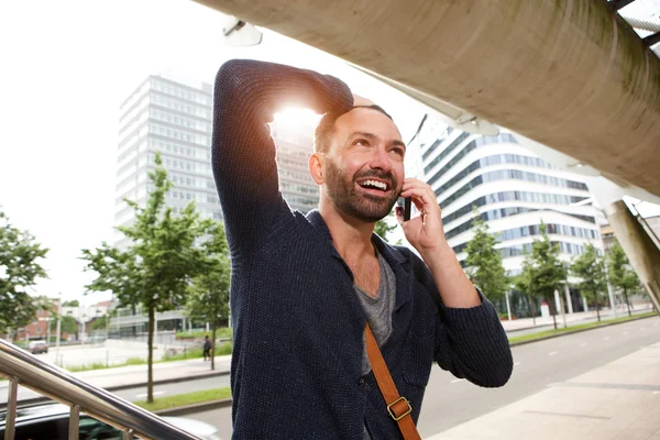 Happy mature guy talking on cell phone