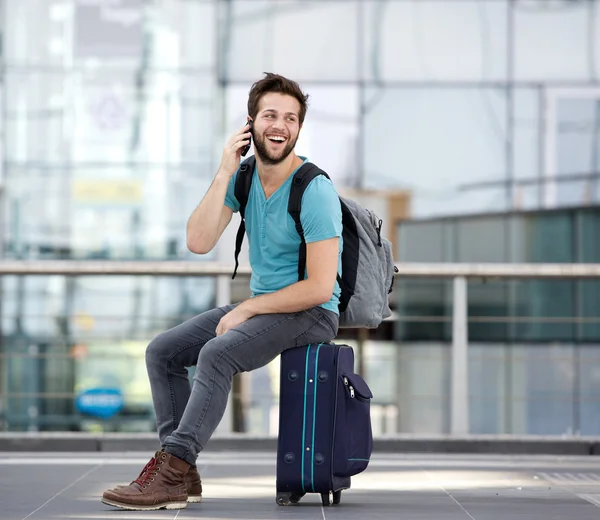 Young man calling by mobile phone at airport
