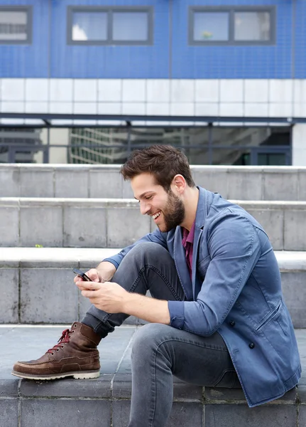 Young man text messaging on mobile phone