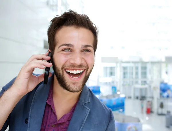 Cheerful young man talking on mobile phone