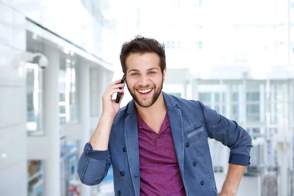 Cool guy smiling with mobile phone