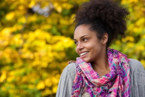 Young african american woman smiling outdoors in autumn