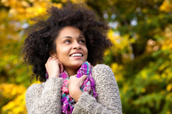 Attractive black woman smiling outdoors in autumn
