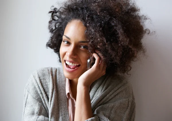Happy young black woman talking on mobile phone