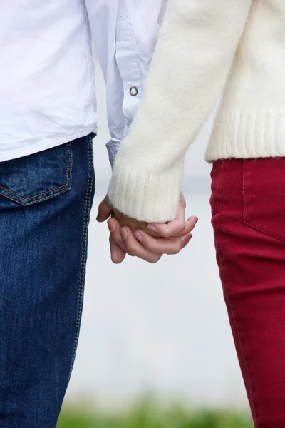 Boyfriend and girlfriend holding hands outdoors