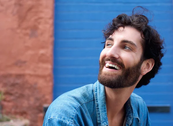 Attractive man with beard laughing