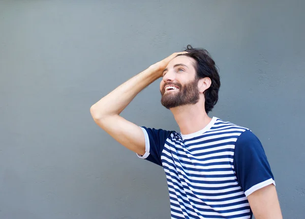 Cool guy smiling with hand in hair