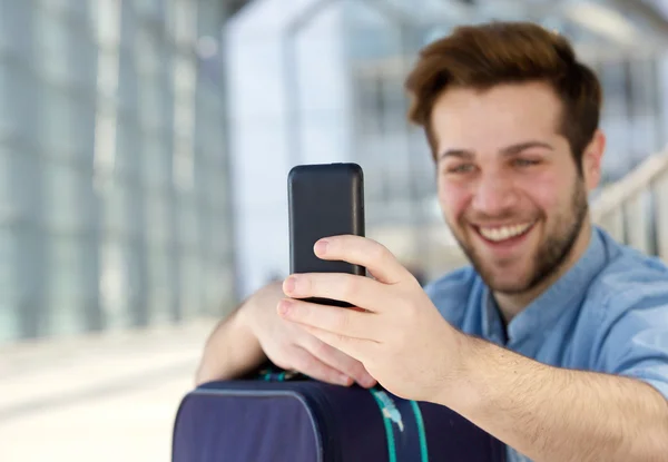 Cool young guy taking selfie with mobile phone