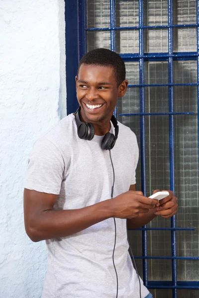 Happy guy with headphones and mobile phone