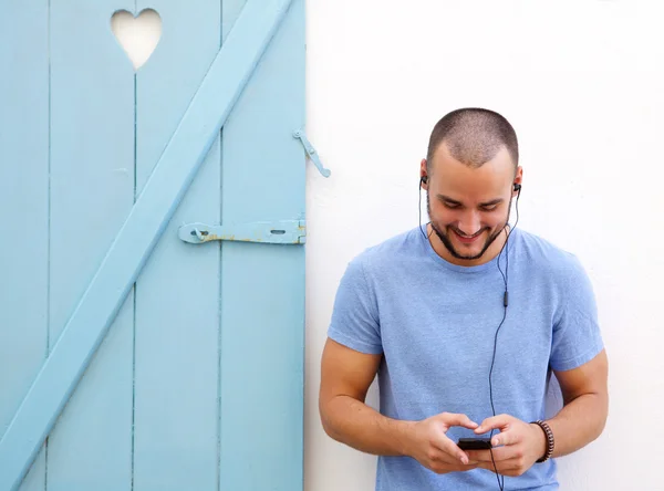 Happy guy listening to music on mobile phone