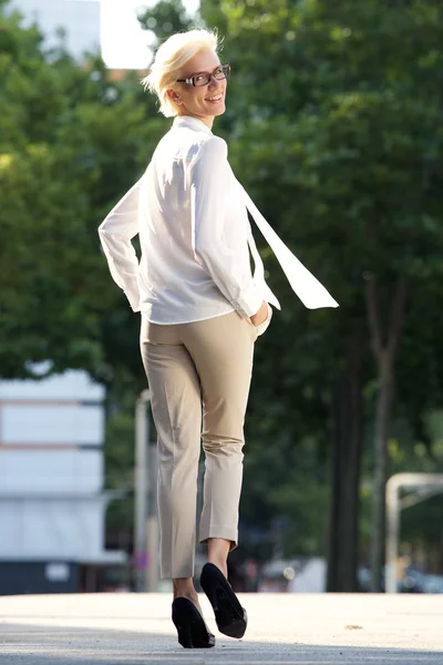 Confident young woman walking away