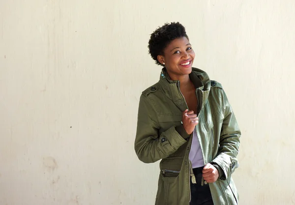 Cool african american woman smiling with green jacket