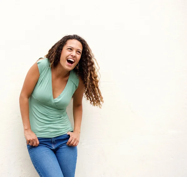 Young woman laughing against white background