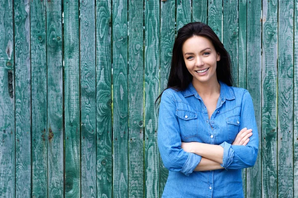 Confident woman smiling with arms crossed