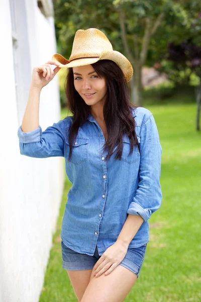 Cool confident young woman with cowboy hat