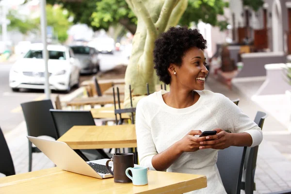 Happy young woman at cafe