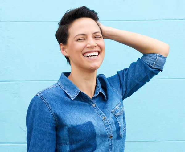 Laughing woman with hand in hair