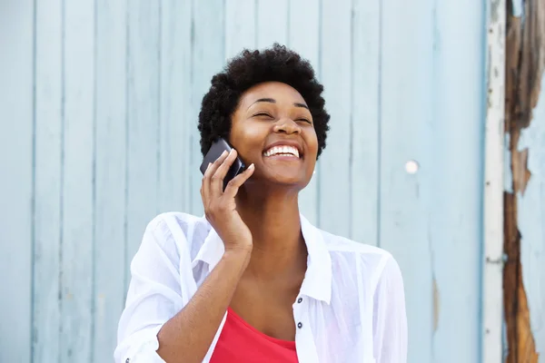 Young smiling woman talking on cell phone