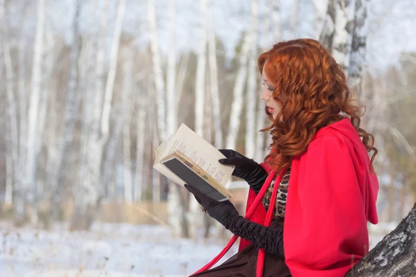 Girl with book in hand . Winter. Surrealism