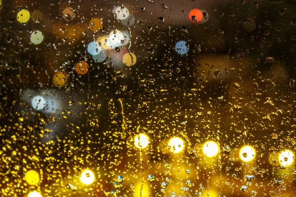 Raindrops on  blurred lights background