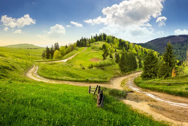 Cross road on hillside meadow in mountain