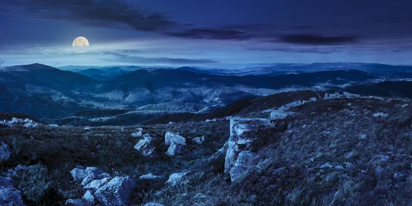 Stones in valley on top of mountain range at night