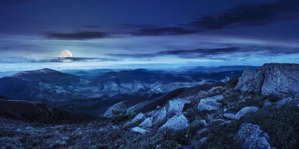 Stones in valley on top of mountain range at night