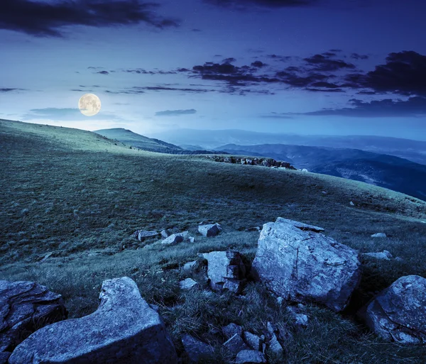 Stones in valley on top of mountain range at night