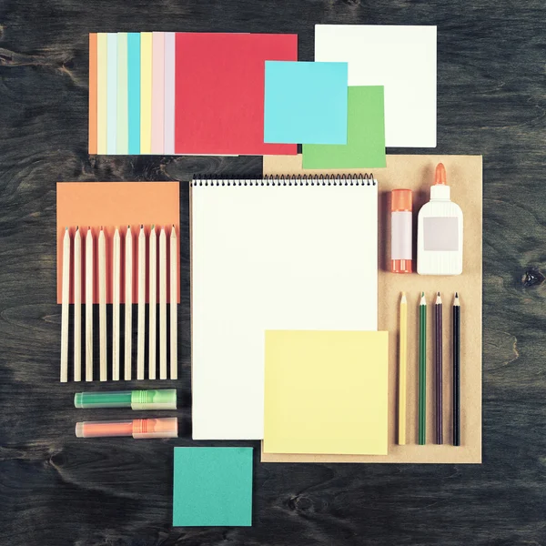 Flat lay office tools and supplies. Top view of desk background. Stationery on wood. Flat design of creative office workspace, workplace.