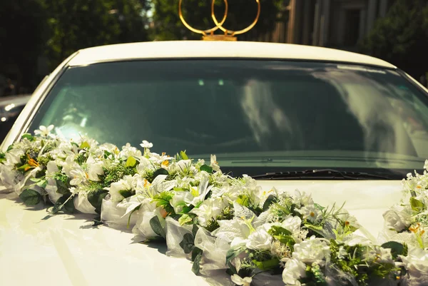 White wedding limousine decorated with flowers