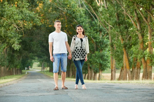 Happy young couple walk on country road outdoor, romantic people concept, summer season