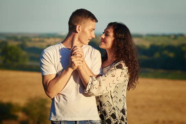 Happy young couple posing high on country outdoor, romantic people concept, summer season