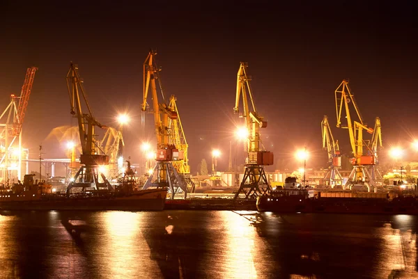 Industrial port with cranes at night