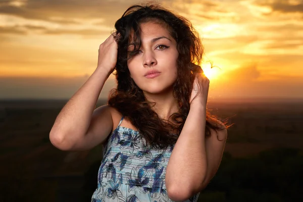 Girl portrait at sunset on plain background