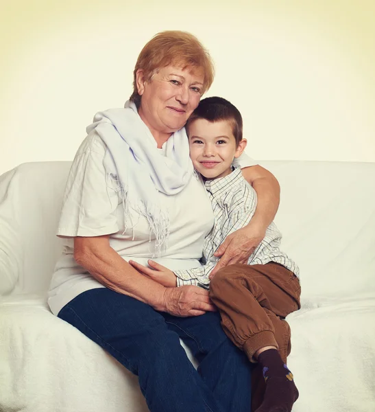 Portrait of child boy and grandmother on white, happy family concept