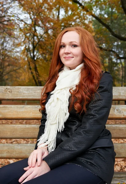 Redhead girl portrait in city park, fall season
