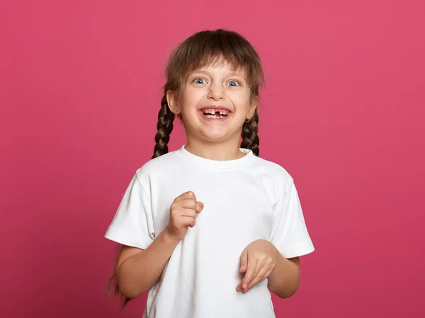 Lost tooth girl child portrait on pink background