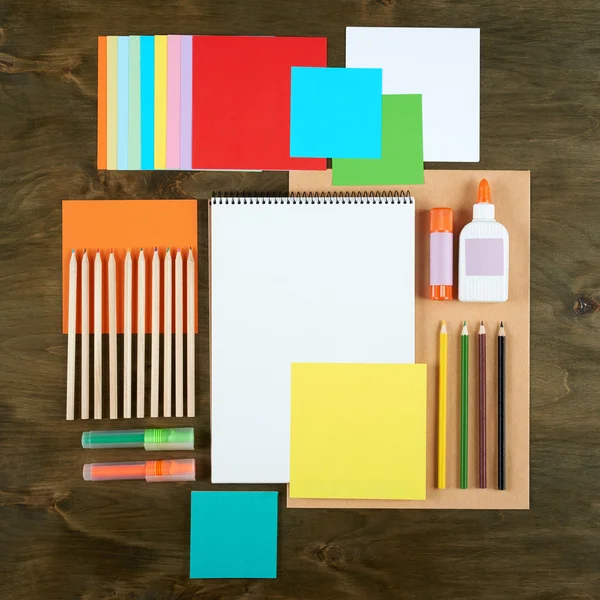 Flat lay office tools and supplies. Education background with stationery on wood. Flat design of creative office workspace, workplace. Top view of desk background.
