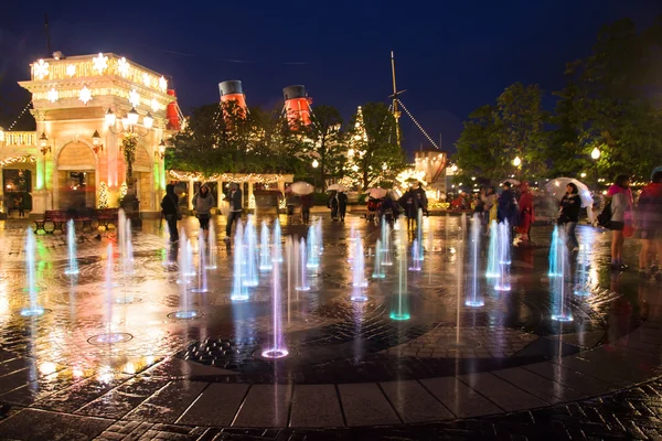 People visit night music fountain in Disney sea