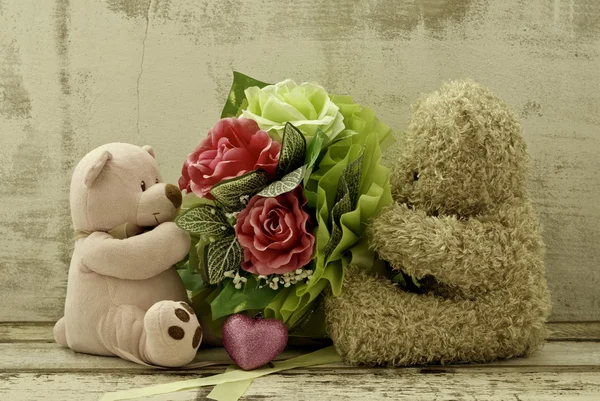 Couple of cute  bears holding roses bouquet