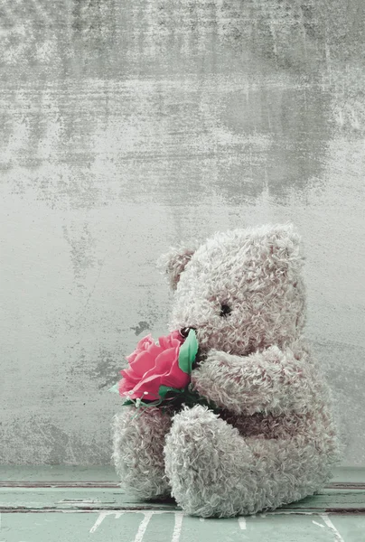 Cute bear doll holding rose bouquet