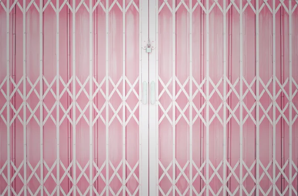 Pink metal grille sliding door with pad lock and aluminium handl