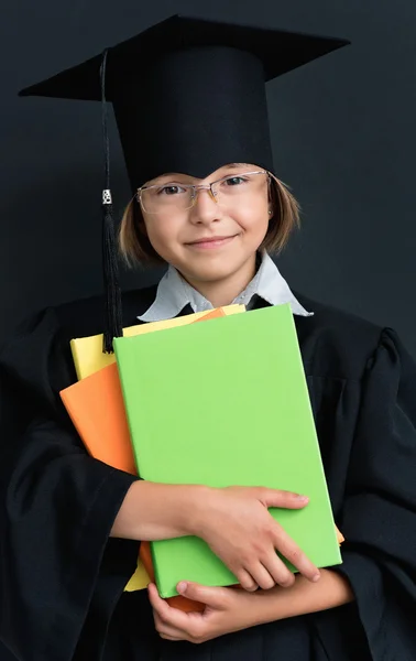 Schoolgirl in academic hat with books