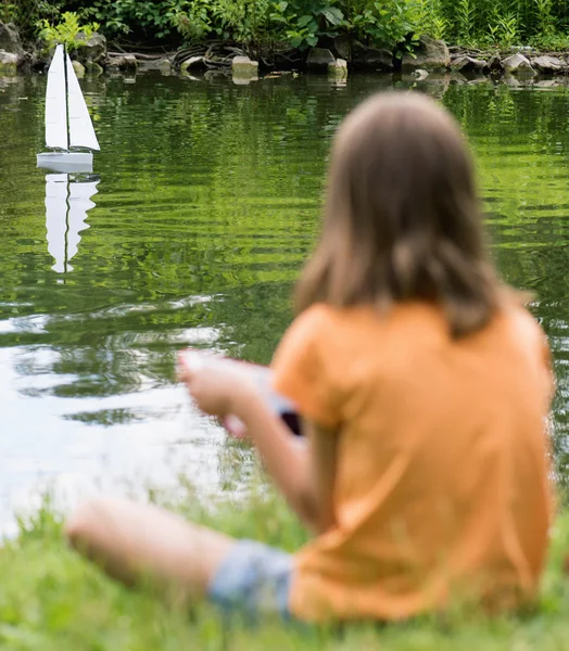 Girl with remote controlled boat