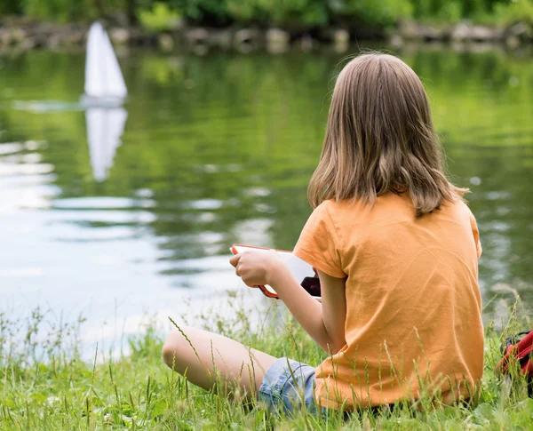 Girl with remote controlled boat